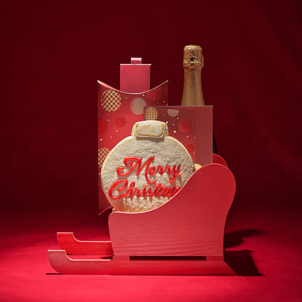 Holiday Sparkling Wine and Gourmet Chocolate Gift in Red Sled Basket – how the gift is presented